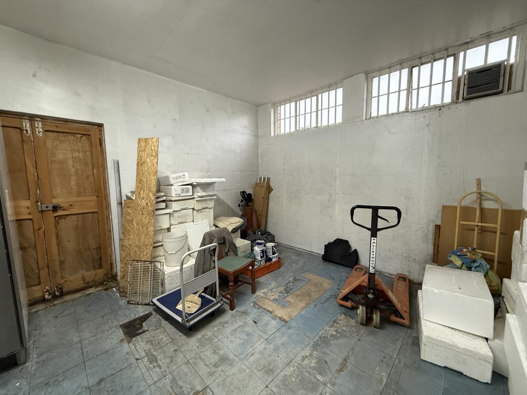 Lot: 117 - FREEHOLD COMMERCIAL RETAIL UNIT WITH FLAT ABOVE FOR INVESTMENT OR REDEVELOPMENT - Rear store room of commercial unit